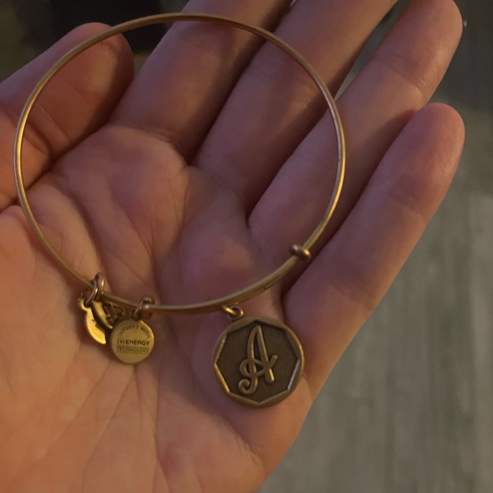 Alex and Ani “A” charm bracelet. “Like new condition,” very slight wear.